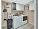 Well-equipped laundry room with a washer, dryer, and overhead storage cabinets at 2329 River Ridge Rd # 4, Deland, FL 32720