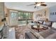 Inviting living room featuring a cozy brown sectional sofa, large windows, and plush area rug at 2329 River Ridge Rd # 4, Deland, FL 32720