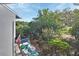 Waterfront view featuring a dock, boat with American flag, and lush greenery under a sunny sky at 2329 River Ridge Rd # 4, Deland, FL 32720