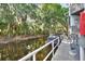 Beautiful canal view alongside a building with boats docked underneath shady trees at 2329 River Ridge Rd # 4, Deland, FL 32720