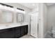 Bathroom featuring double vanity, walk-in shower with glass door, and clean, neutral finishes at 2406 Kennington Cv, Deland, FL 32724