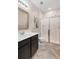 This bathroom features a glass-enclosed shower and a single sink vanity at 2406 Kennington Cv, Deland, FL 32724