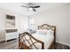 Cozy bedroom features a decorative wood-frame bed, beach-themed artwork, and ample natural light at 2406 Kennington Cv, Deland, FL 32724