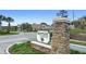 Attractive community sign 'Bentley Green' at the entrance, showcasing the neighborhood's identity and landscaping at 2406 Kennington Cv, Deland, FL 32724