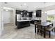 Modern kitchen featuring stainless steel appliances, an island with a white countertop, and a dining area at 2406 Kennington Cv, Deland, FL 32724