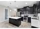 Stylish kitchen with dark cabinets, stainless appliances, and a center island at 2406 Kennington Cv, Deland, FL 32724