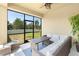 Inviting screened patio with comfortable wicker furniture, perfect for outdoor relaxation and entertainment at 2406 Kennington Cv, Deland, FL 32724