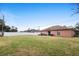 Relaxing backyard with a white privacy fence, lush green lawn and patio area for entertaining at 2448 Newmark Dr, Deltona, FL 32738