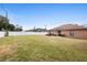 Spacious backyard with a well-kept lawn, patio seating, and a privacy fence, great for outdoor relaxation at 2448 Newmark Dr, Deltona, FL 32738
