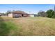 Large backyard with room to roam, featuring mature trees and a well-maintained lawn at 2448 Newmark Dr, Deltona, FL 32738