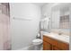 Bathroom with neutral decor, wood cabinet vanity, and shower with curtain at 2448 Newmark Dr, Deltona, FL 32738