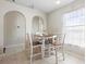 Cozy dining area adjacent to the kitchen features white and wood bar-height chairs and neutral paint at 2448 Newmark Dr, Deltona, FL 32738