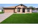 Charming single-story home featuring a well-manicured lawn, neutral paint, attached garage and a welcoming front entrance at 2448 Newmark Dr, Deltona, FL 32738