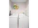 Functional laundry room with a washer, dryer, and overhead shelving at 2448 Newmark Dr, Deltona, FL 32738