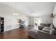 Bright living room with hardwood floors, vaulted ceilings, and a sliding glass door to the backyard at 2448 Newmark Dr, Deltona, FL 32738