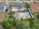 Aerial view of property with large backyard, patio, mature trees, and well-maintained landscaping at 2486 Shiprock Ct, Deltona, FL 32738
