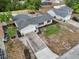 Aerial view of property showing long driveway, lush trees, and updated landscaping at 2486 Shiprock Ct, Deltona, FL 32738