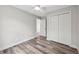 Bedroom featuring wood-look floors, white trim, closet and a ceiling fan at 2486 Shiprock Ct, Deltona, FL 32738