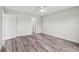 Bright bedroom featuring wood-look floors, white trim, neutral walls, and a ceiling fan at 2486 Shiprock Ct, Deltona, FL 32738