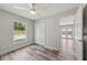 Bedroom featuring wood-look floors, white trim, closet and a ceiling fan at 2486 Shiprock Ct, Deltona, FL 32738