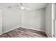 Bright bedroom with wood-look floors, neutral walls, white trim, and a ceiling fan at 2486 Shiprock Ct, Deltona, FL 32738