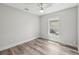 A bedroom featuring new wood floors, a ceiling fan, a window, and painted in light, neutral colors at 2486 Shiprock Ct, Deltona, FL 32738