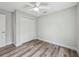 Bedroom featuring wood-look floors, white trim, closet and a ceiling fan at 2486 Shiprock Ct, Deltona, FL 32738