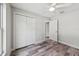 Bedroom featuring wood-look floors, white trim, closet and a ceiling fan at 2486 Shiprock Ct, Deltona, FL 32738