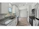 Well-lit kitchen showcasing white cabinetry, granite countertops, and stainless steel appliances at 2486 Shiprock Ct, Deltona, FL 32738