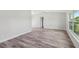 Airy main bedroom featuring vaulted ceilings, a large window, and wood-look flooring at 2486 Shiprock Ct, Deltona, FL 32738