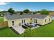 Aerial view of a newly renovated outdoor patio with seating and a freshly installed lawn at 2486 Shiprock Ct, Deltona, FL 32738