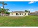 Home featuring a large backyard with a concrete patio and well-maintained lawn at 2526 Chester Ave, New Smyrna Beach, FL 32168