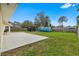Expansive backyard with lawn and patio, with plenty of room for outdoor activities and relaxation at 2526 Chester Ave, New Smyrna Beach, FL 32168