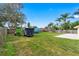 Spacious backyard with lawn and a concrete patio, partially fenced, offering ample space for recreation at 2526 Chester Ave, New Smyrna Beach, FL 32168