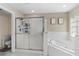 Bathroom featuring a large shower, tub, and tile flooring at 2526 Chester Ave, New Smyrna Beach, FL 32168