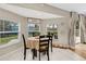 Cozy breakfast nook with abundant natural light from the surrounding windows and sliding door at 2526 Chester Ave, New Smyrna Beach, FL 32168