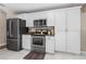 Updated kitchen featuring stainless appliances, granite countertops and modern white cabinetry at 2526 Chester Ave, New Smyrna Beach, FL 32168