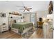 Comfortable main bedroom with modern decor, wooden floors and ceiling fan at 2526 Chester Ave, New Smyrna Beach, FL 32168