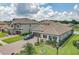 Home exterior with mature landscaping, brick driveway, and elegant front porch at 260 Teddy Rushing St, Debary, FL 32713