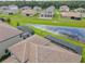 Aerial view featuring a tile roof with a screened-in pool and pond at 260 Teddy Rushing St, Debary, FL 32713