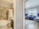 Bathroom view through an open doorway into a home office, featuring tile flooring and natural lighting at 260 Teddy Rushing St, Debary, FL 32713