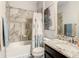 Bathroom with tiled shower-tub combination and granite vanity at 260 Teddy Rushing St, Debary, FL 32713