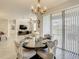Open-concept dining room featuring a modern chandelier and sliding glass doors to the patio at 260 Teddy Rushing St, Debary, FL 32713
