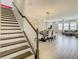Open-concept dining room with stone accent wall and staircase to the second floor at 260 Teddy Rushing St, Debary, FL 32713