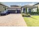 Charming two-story home with a tile roof, landscaped yard, brick driveway, and two-car garage at 260 Teddy Rushing St, Debary, FL 32713