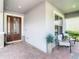 Inviting front porch with brick flooring, comfortable seating, and a beautifully decorated entrance at 260 Teddy Rushing St, Debary, FL 32713