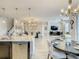 Open kitchen with granite island looking into the dining and living room and staircase at 260 Teddy Rushing St, Debary, FL 32713