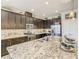 Modern kitchen featuring dark wood cabinets, granite countertops, and stainless steel appliances at 260 Teddy Rushing St, Debary, FL 32713