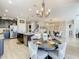 Spacious kitchen with granite countertops, large island, and stainless steel appliances near dining area at 260 Teddy Rushing St, Debary, FL 32713