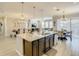Bright, open kitchen with granite counters and large island overlooking dining and living areas at 260 Teddy Rushing St, Debary, FL 32713